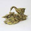 BR6004 - Solid brass statue of 2 swans. one swimming by a nest the other is standing on the nest guarding her eggs